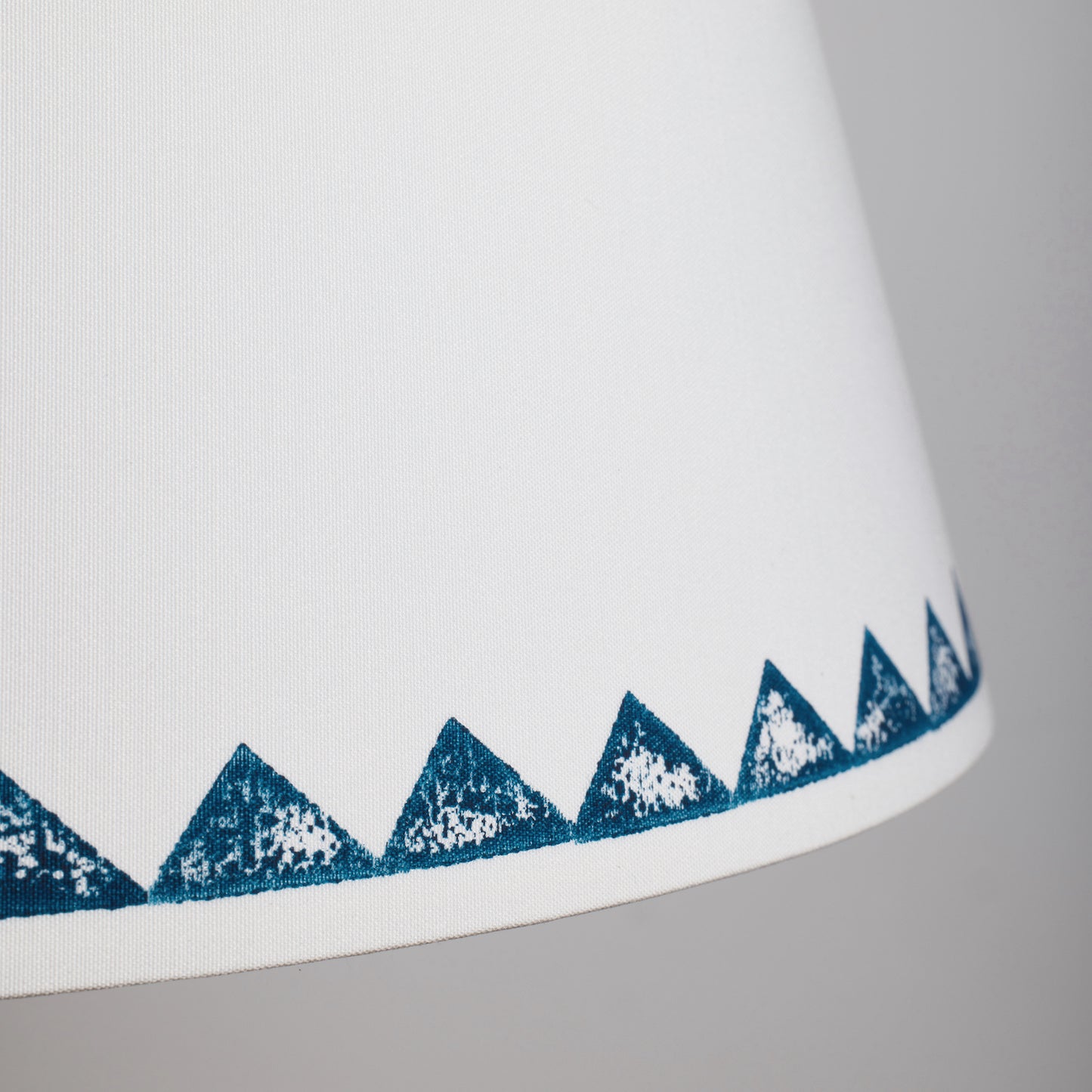 Detailed view Studio Zef's Trigon blue lampshade showing textured triangle motifs, a lampshade with triangle pattern that highlights the handmade detail.