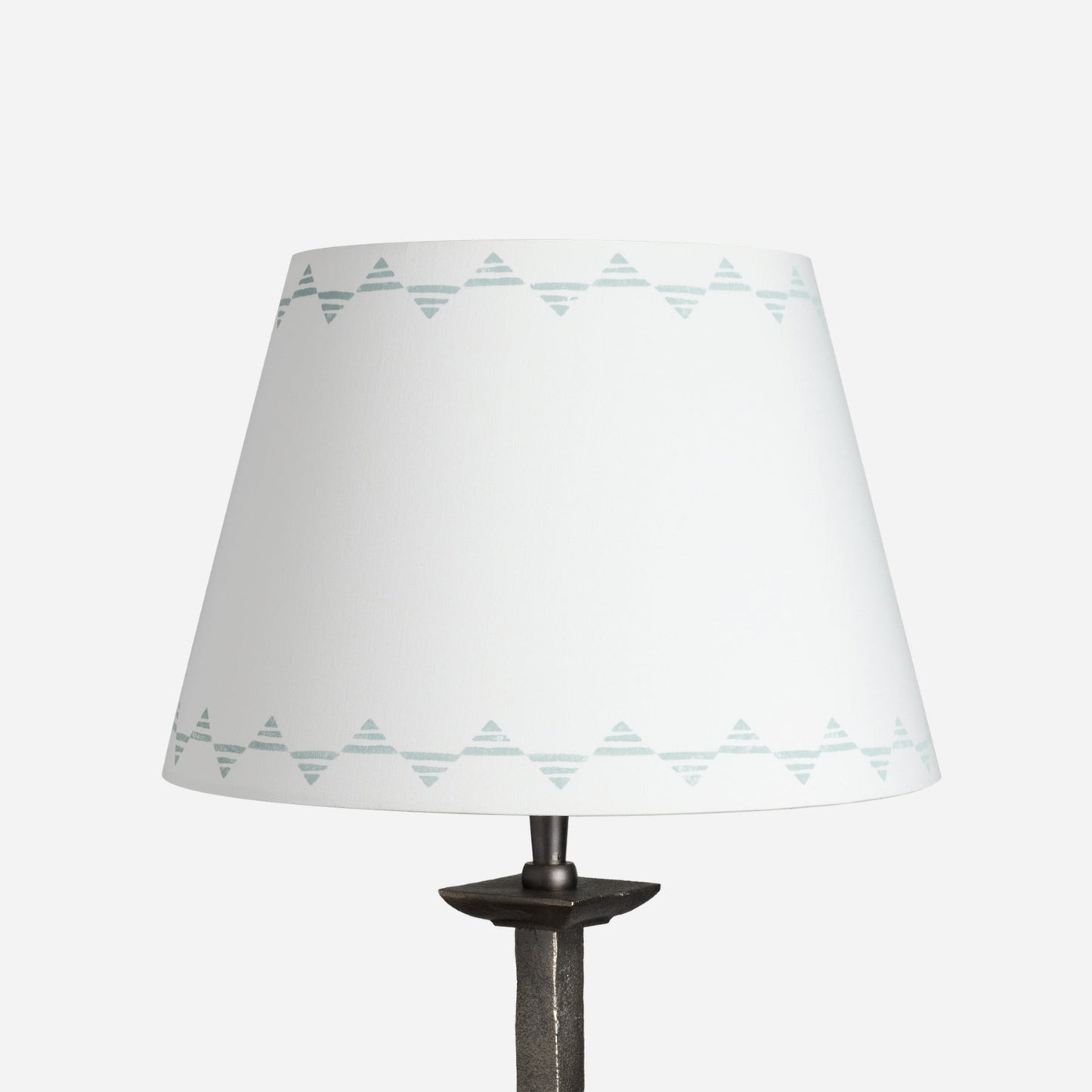 Empire lampshade in cream cotton with a blue triangle pattern, a geometric lampshade design shown on a plain white background.