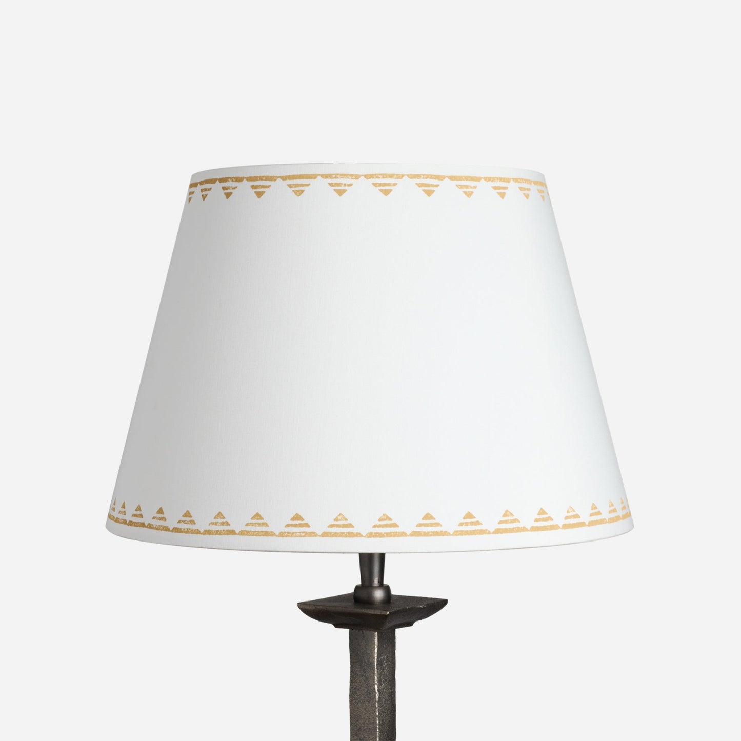 Full product image of the Lined Trigon Lampshade in a soft cream fabric, decorated with a neat yellow triangle border. The empire lampshade showcases a geometric lampshade design perfect for both classic and contemporary interiors.