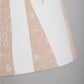 Close-up of cream lampshade with geometric triangle pattern in soft pink. This empire shade combines bold lampshade design with a neutral finish, ideal for modern and classic interiors.