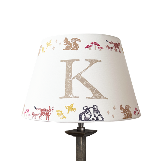 Personalised kids lampshade with woodland animals printed around the top and bottom, and a letter printed in the middle