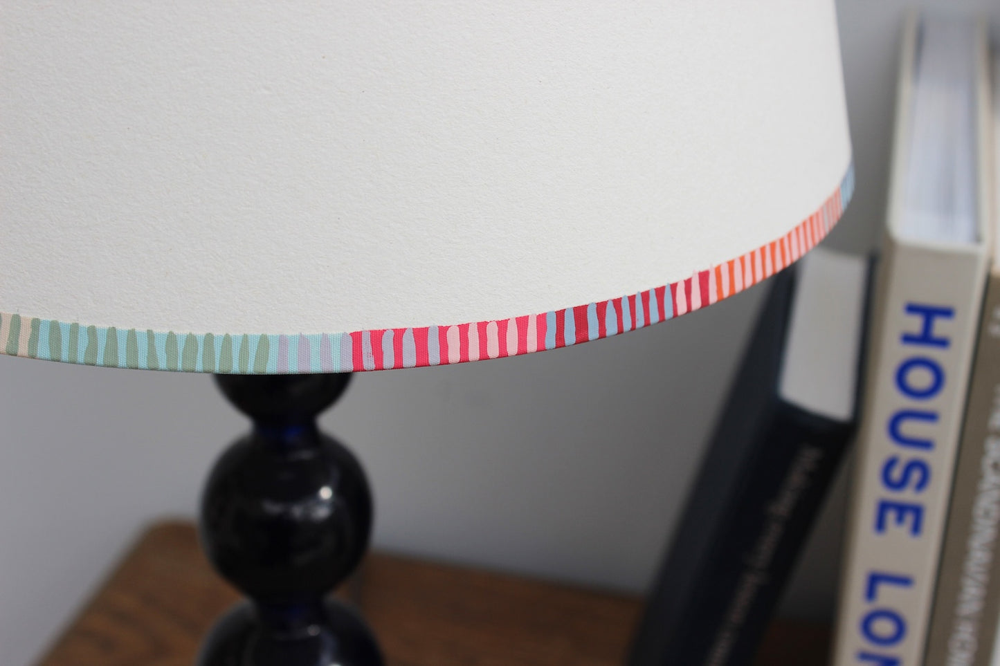 A bold stripe lampshade with a playful, colourful striped border in pink, red, blue, and green. This pretty lampshade adds a pop of striped lighting detail, perfect for modern interiors and striped lampshades UK collections.