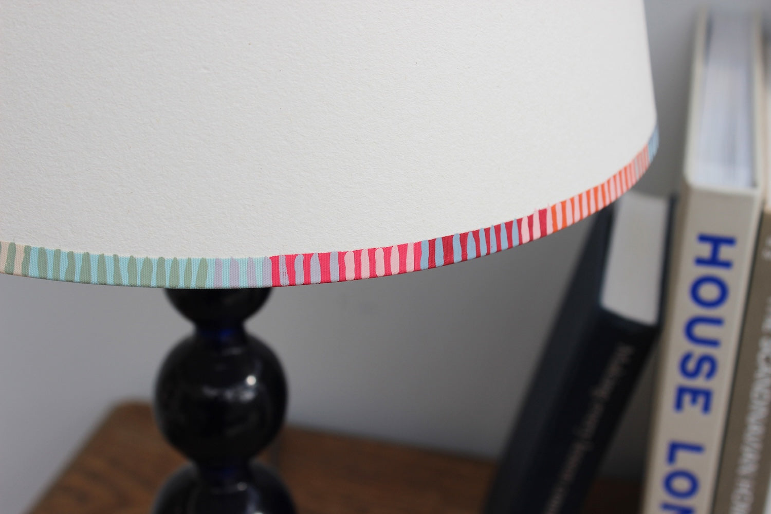 A bold stripe lampshade with a playful, colourful striped border in pink, red, blue, and green. This pretty lampshade adds a pop of striped lighting detail, perfect for modern interiors and striped lampshades UK collections.