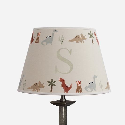 Personalised dinosaur lampshade with initial S, decorated with colourful dinosaurs, volcanoes, palm trees and cacti on a cream empire shade.