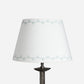 Empire lampshade in cream cotton with a blue triangle pattern, a geometric lampshade design shown on a plain white background.