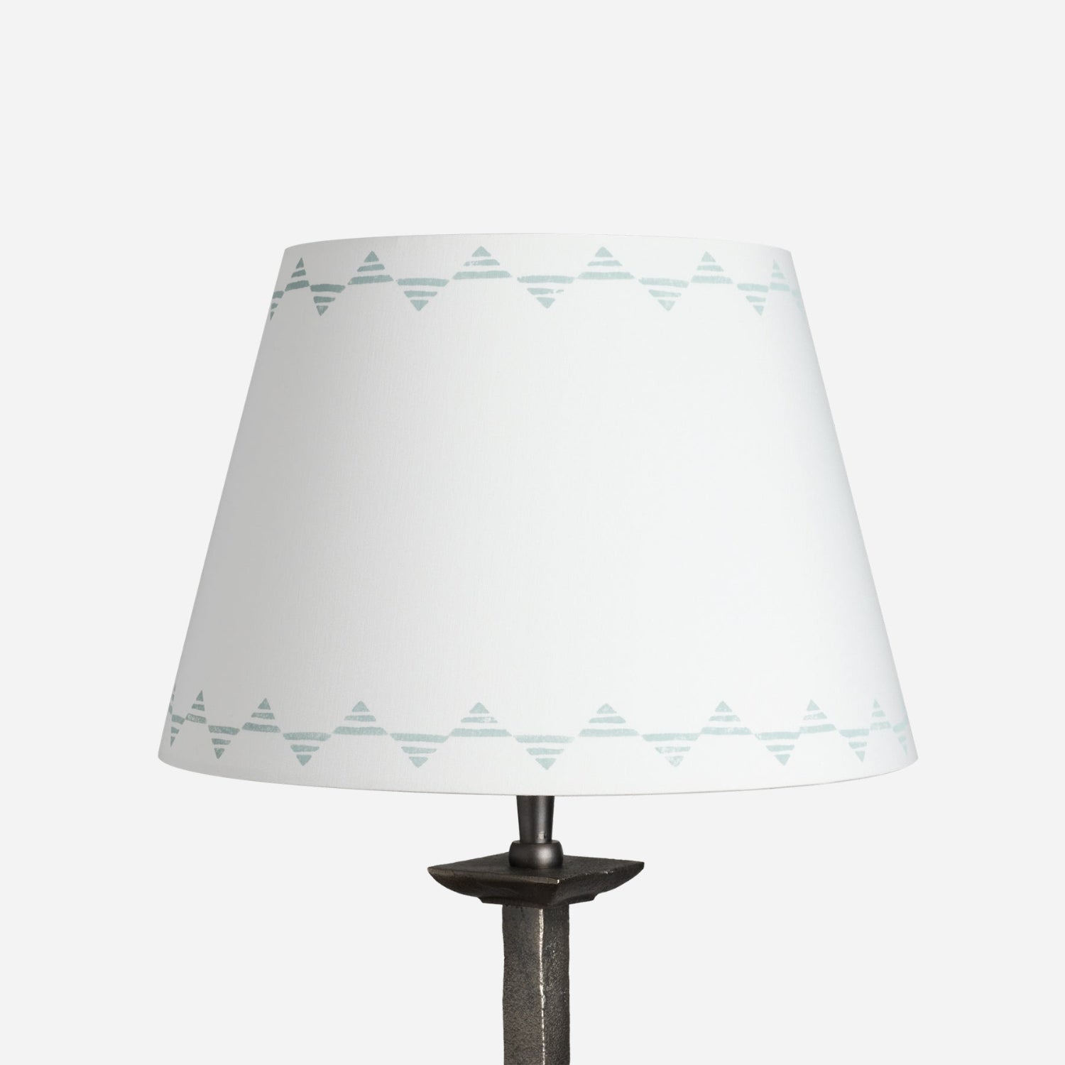 Empire lampshade in cream cotton with a blue triangle pattern, a geometric lampshade design shown on a plain white background.