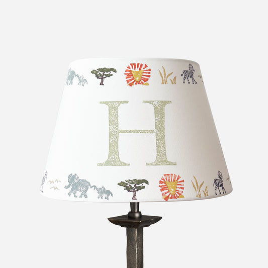 Studio Zef product image of a personalised kids safari lampshade with letter H. Empire lampshade featuring safari animals, perfect as a boys lampshade, kids lighting or presents for new parents.