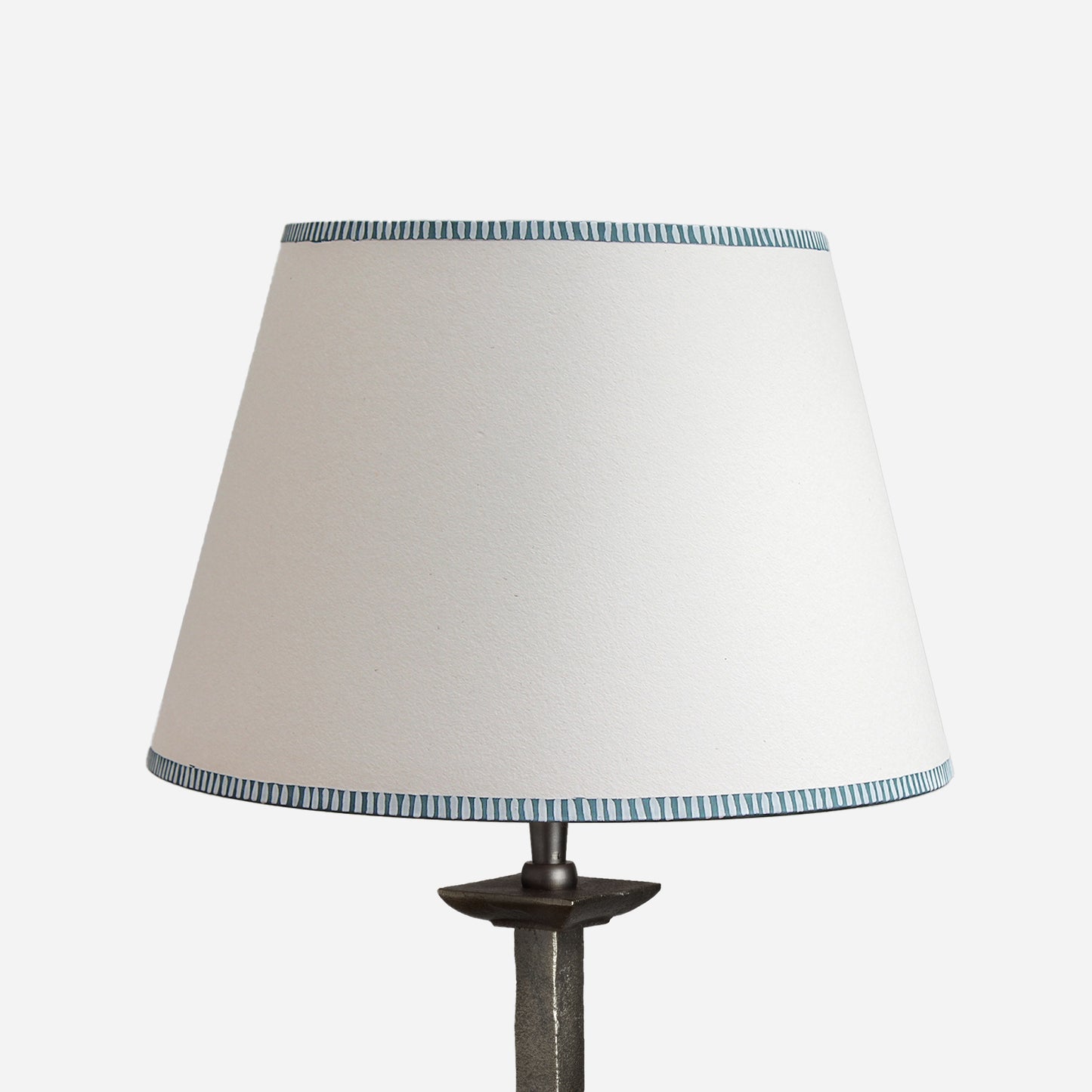 Empire lampshade with a subtle blue striped edge trim, designed as a bold lampshade with a minimalist twist. This stylish empire light shade combines classic white with fine blue stripe accents, making it a versatile striped lampshade for table lamps. A modern yet timeless choice for striped lampshades UK, ideal for creating understated striped lighting.