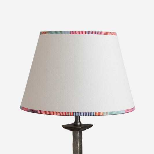 Empire lampshade with a colourful striped edge design, perfect as a bold stripe lampshade for table lamps. This modern empire light shade features vibrant red, pink, blue, and orange striped detailing along the top and bottom rims, adding a playful touch to striped lighting in any interior. A pretty lampshade ideal for UK homes looking for unique striped lampshades.