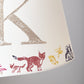 Close-up of a personalised kids lampshade with woodland animals design, featuring a fox and the letter K. Handmade empire lampshade ideal for kids bedroom decor, animal lampshade for boys lampshade or girls lighting. Perfect as a personalised kids gift, personalised christening present, or new parent gift.