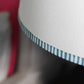 Close-up of bold stripe lampshade featuring hand-painted striped edge in blue. A pretty lampshade detail that shows the craftsmanship behind Studio Zef’s striped lampshades UK collection.