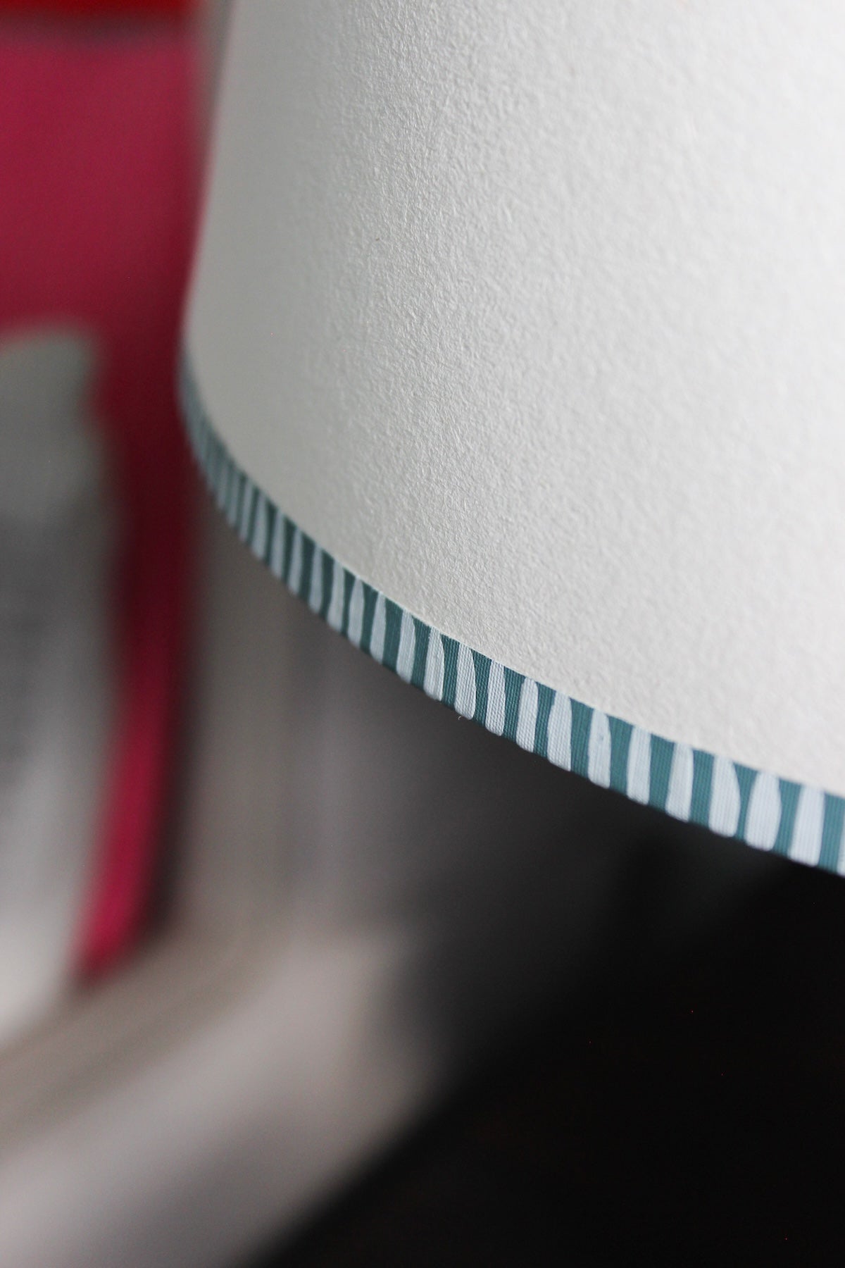 Close-up of bold stripe lampshade featuring hand-painted striped edge in blue. A pretty lampshade detail that shows the craftsmanship behind Studio Zef’s striped lampshades UK collection.