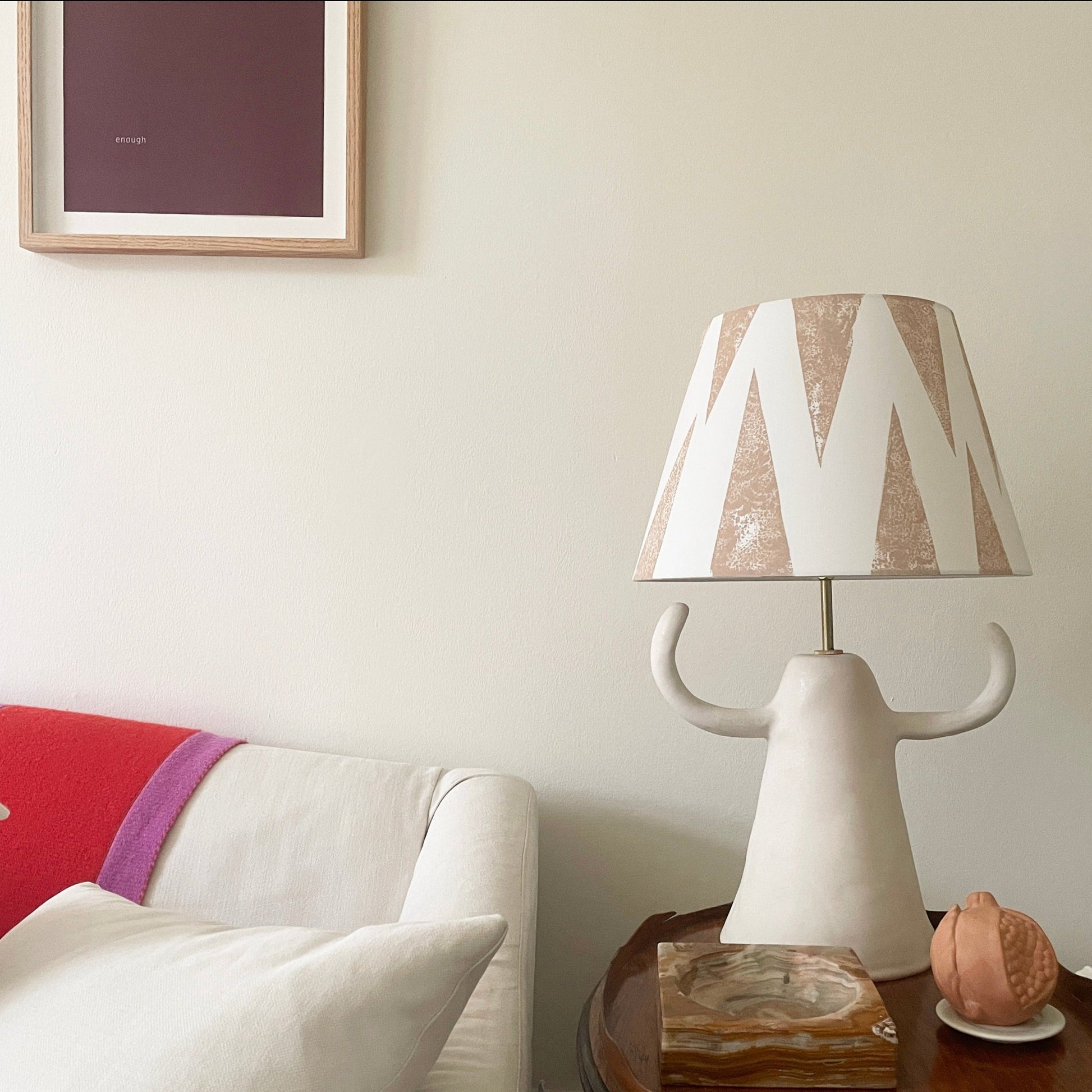 Light pink lampshade on side table next to sofa